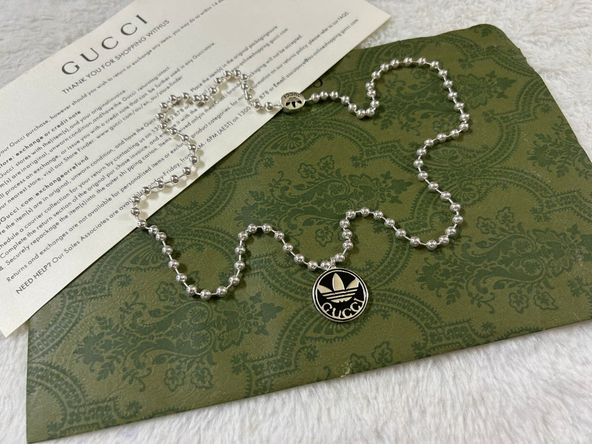 Double Gucci x Adidas Pendant Boule Necklace product image 9, provided for visual reference and product detail review