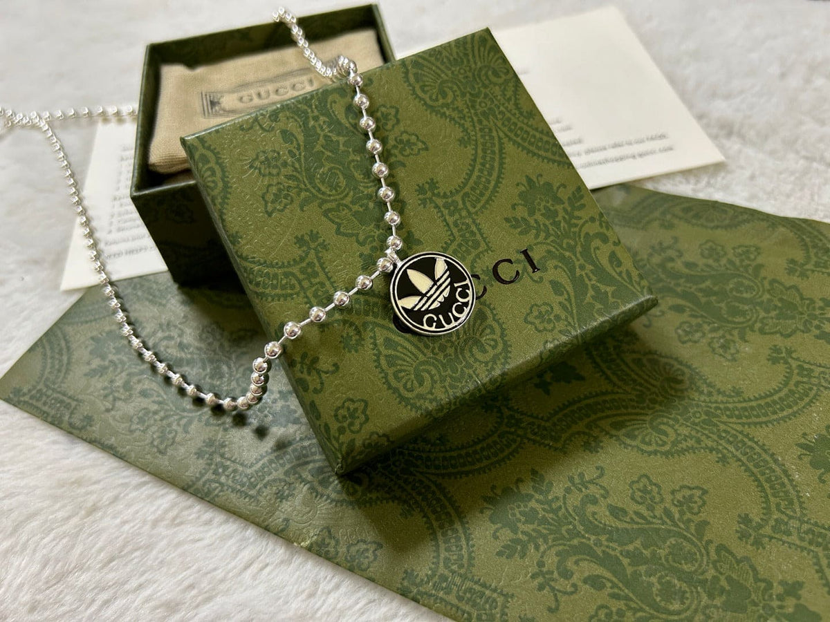 Double Gucci x Adidas Pendant Boule Necklace product image 7, provided for visual reference and product detail review