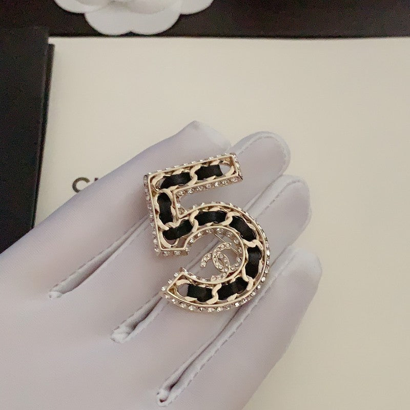 Chanel No.5 Leather Diamond 18K Gold Brooch product image 1, provided for visual reference and product detail review