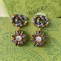 Gucci Double Flower Pendant 18K Gold Earrings product image 1, provided for visual reference and product detail review