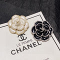 Chanel Camellia Black & White 18K Gold Brooch product image 1, provided for visual reference and product detail review