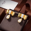 Celine Butterfly Pearl Pendant 18K Gold Earrings product image 1, provided for visual reference and product detail review
